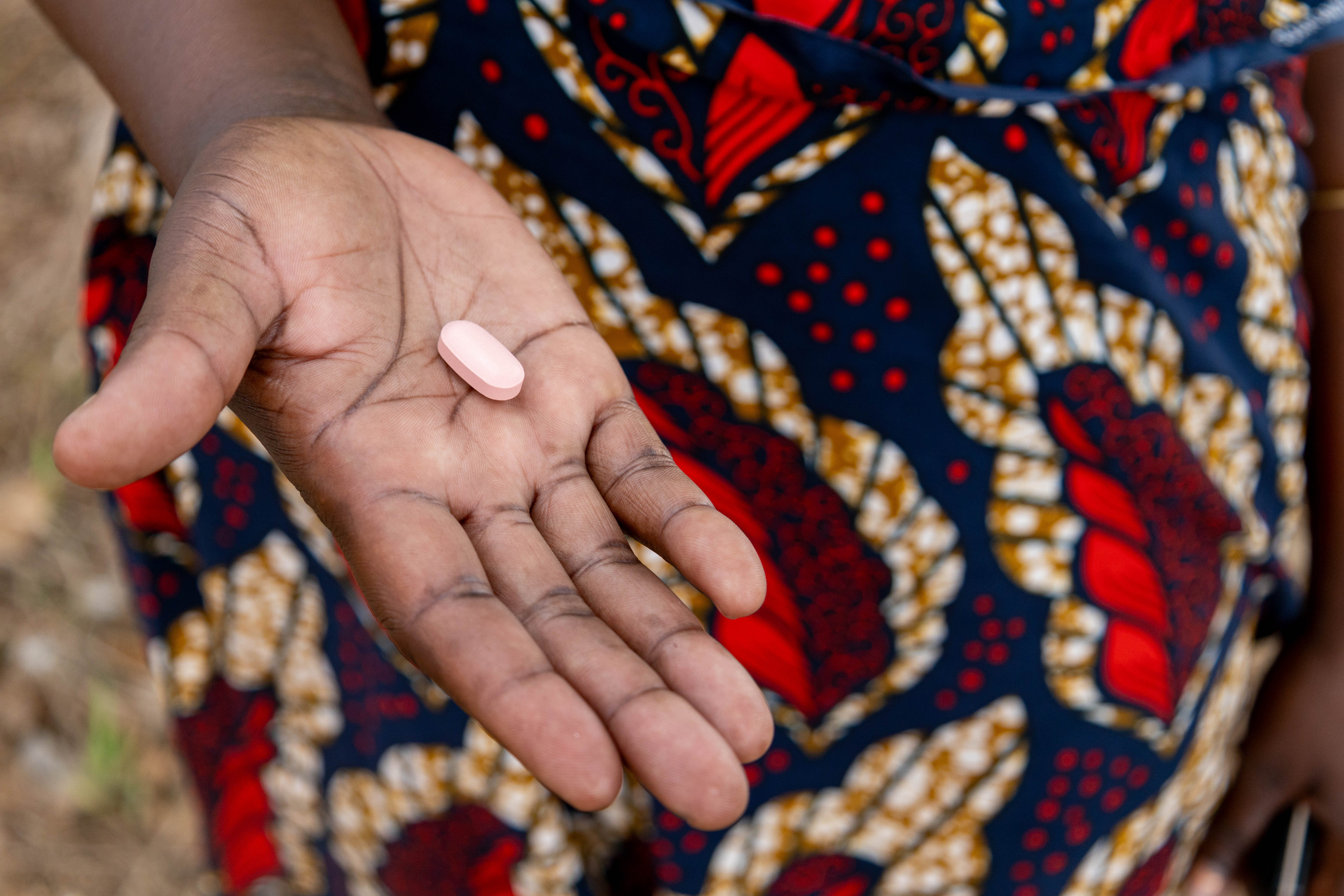 Hand holding out HIV medicine