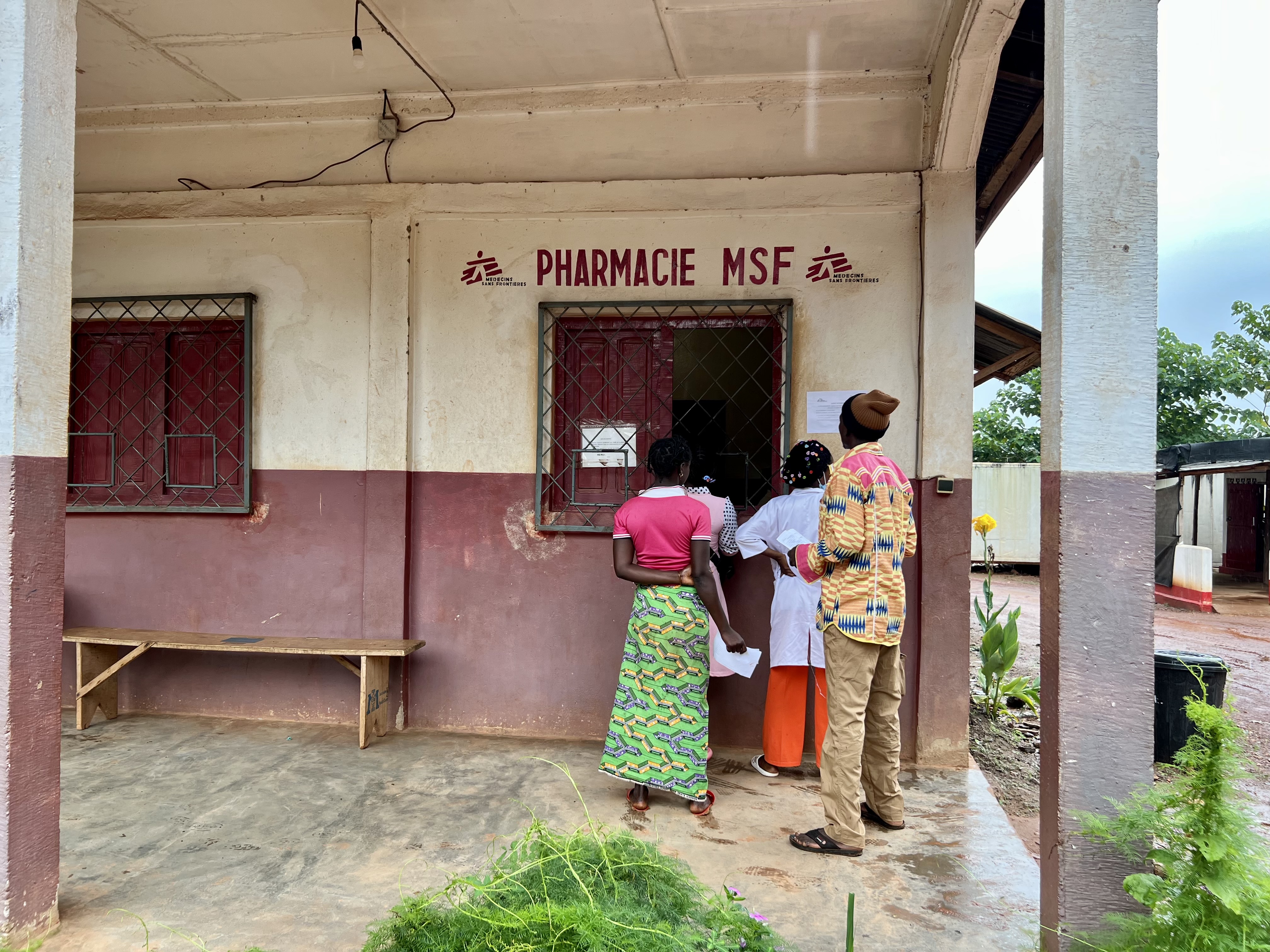 People standing before an MSF pharmacy